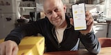 Jürgen Vogel zeigt Handy mit Post & DHL App
